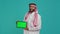 Muslim man presents greenscreen tablet