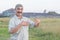 Muslim man stands and talks about something funny against the background of a Siberian village, Russia