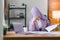 The Muslim millennial woman wearing a purple hijab appears stressed while working on her laptop from home, looking