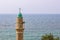 Muslim minaret tower Eastern religion architecture building moody weather Bosporus strait sea waters horizon landscape background