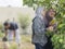 Muslim Mother and Daughter Harvesting Fruit at Home Garden