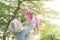 Muslim mother playing with daughter at park