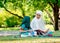 Muslim mother teach her daughter to read religion textbook for understanding the way of good life. They stay in the green garden