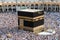 Muslim pilgrims revolving around the Kaaba in Mecca Saudi Arabia. Muslim people praying together at holy place.