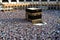 Muslim pilgrims revolving around the Kaaba in Mecca Saudi Arabia. Muslim people praying together at holy place.