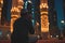 Muslim prayer sitting in front of mosque at Ramadan night with selective focus, neural network generated image