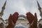 Muslim praying hands, mosque and minaret background