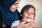 Muslim traditional woman with son at kitchen