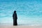 Muslim woman in abaya by the seaside
