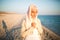 Muslim woman on the beach spiritual portrait.Humble muslim woman praying on the beach.Summer holiday,muslim woman walking