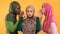 Muslim Woman Covering Ears Not Listening Her Friends, Yellow Background