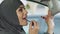 Muslim woman doing makeup in car while stuck in traffic jam, risk of accident