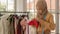Muslim woman dressmaker in hijab working in fashion design shop