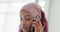 Muslim woman, frustrated and phone call in communication with hijab having a conversation at home. Islamic female in