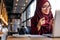 Muslim woman having a video chat on laptop at cafe