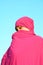 Muslim woman hiding behind scarf