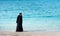 Muslim woman in hijab by the seaside