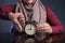 Muslim Woman Holding Clock Pointing at Nine O& x27;Clock, Lateness Concept