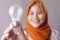 Muslim Woman Holds Lamp Bulb