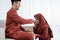 Muslim woman kneel bow and kissing hands to his husband for apologize