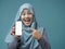 Muslim Woman Looking at Camera Smiling and Shows Smart Phone, Phone Mock Up