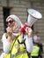 Muslim woman with megaphone at the counter-demo by pressure group Unite Against Fascism in Whitehall, London, UK.