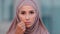 Muslim woman outdoors islamic girl in hijab showing zip gesture shutting mouth on key keeping silence lips shut, secret