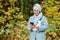 Muslim woman at the park using smartphone connected online wireless. Space for advertisement