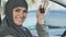 Muslim woman showing keys, excited with car purchase, driving gender equality