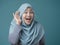 Muslim Woman Smiling While Doing Hearing Gesture