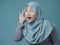 Muslim Woman Smiling While Doing Hearing Gesture
