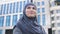 Muslim woman standing near university building, higher education opportunity