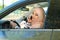 Muslim woman talking on phone in driver`s seat