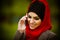 Muslim woman talking on the phone and using technology. Muslim woman is using smart phone