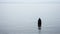 A Muslim woman in a veil or veil walks along the beach near the ocean.