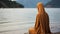 A Muslim woman in a veil or veil walks along the beach near the ocean.