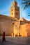 Muslim woman walk by Koutoubia Mosque,Morocco