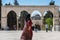 Muslim woman walking out of  the square of the Golden Dome of the Rock