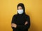 Muslim woman wearing hijab and mask during coronavirus covid pandemic new normal, woman wearing face protective mask, against