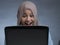 Muslim Woman Working on Laptop and Smiling