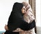 Muslim women hugging each other