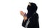 A muslim women pray looking up from side wide