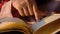 Muslim women's hand reading quran at night