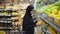 Muslim women shopping for groceries, taking fruits from the shelf
