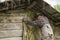 Muslim women in traditional clothing close the warehouse door by