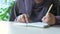 Muslim women women hand writing on notepad.