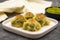 Mussel baklava. Pistachio baklava on a dark background. Mediterranean cuisine delicacies.