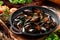 Mussel shells in vegetable broth in a black cauldron on a dark wooden background, decorated with vegetables