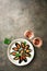 Mussels with spices, parsley and two glasses of pink sparkling wine, dark rustic background. Top view, flat lay, copy space