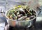 Mussels steamed with vegetables in a stainless steel pot.